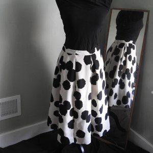 Tea length black polka dot skirt.